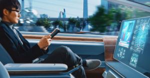 passenger reading a book in an autonomous self-driving car